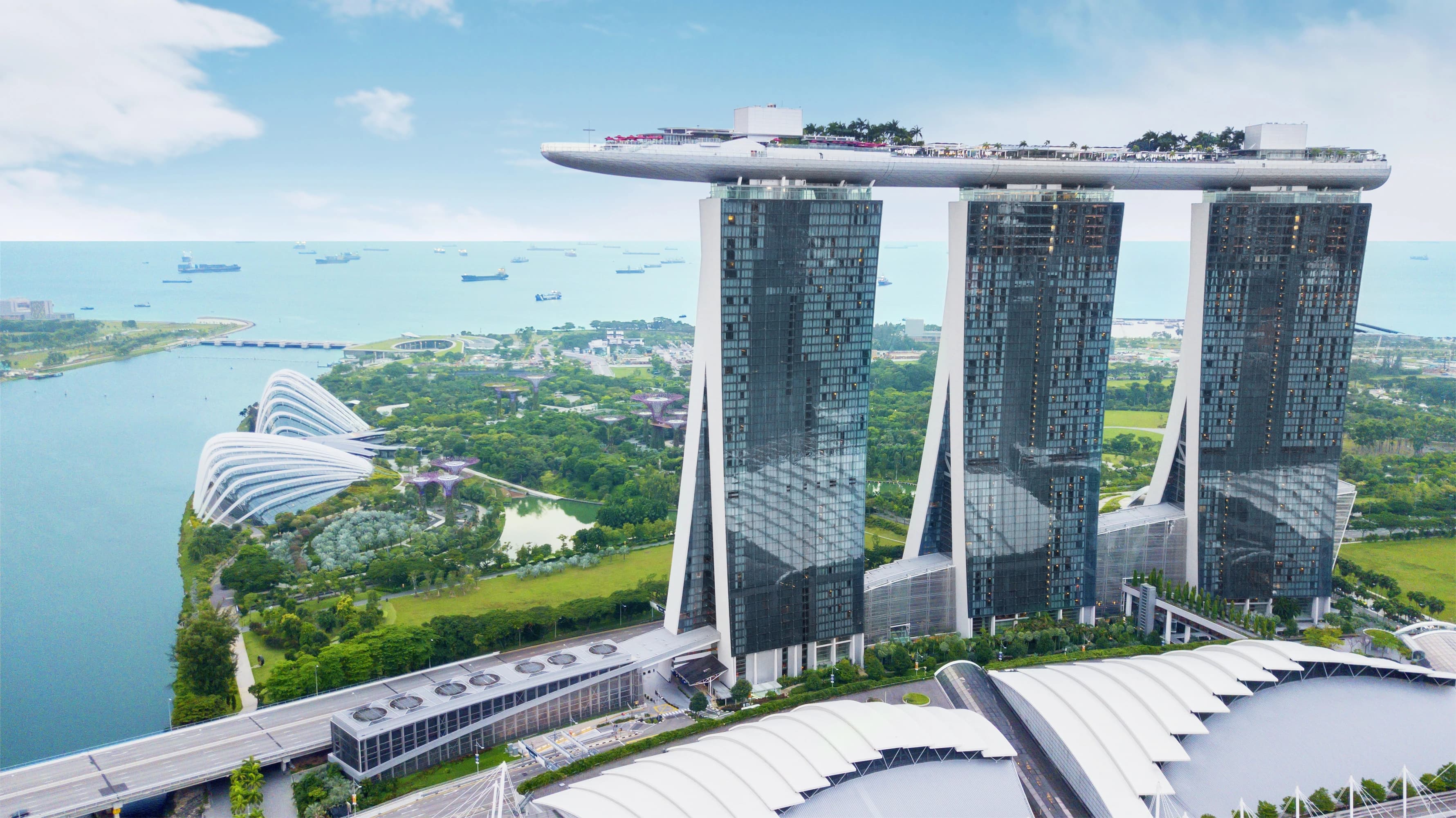 Singapore reflected in water under a clear sky